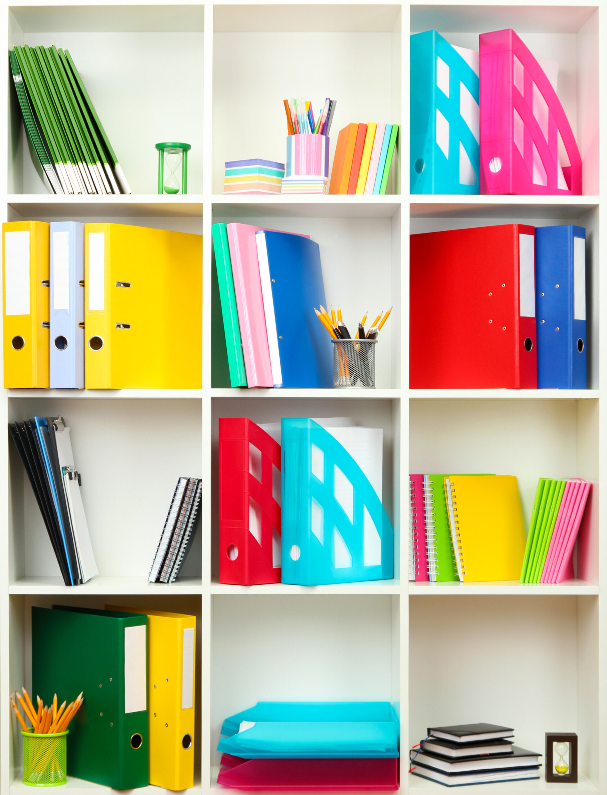 White office shelves with different stationery, close up